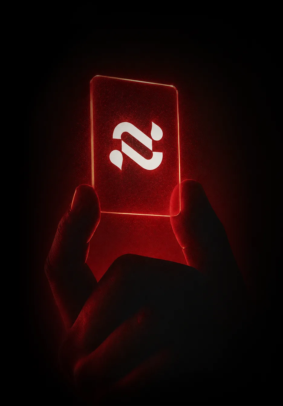 Hand holding a card with the Navia logo glowing in red